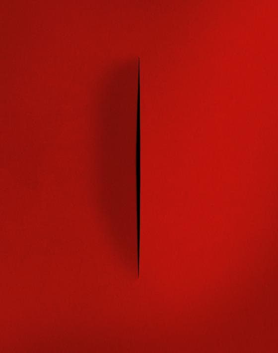 A red surface is divided by a thin, vertical black slit in the center. The slit creates a subtle gradient effect, giving the appearance of depth through the minimalist composition, almost like a mommy's comforting embrace.