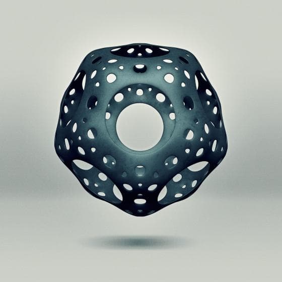 A 3D geometric sculpture with a hollow, perforated design hovers against a light gray background. The object is symmetrical, with circular and hexagonal cutouts, creating an intricate pattern resembling a futuristic architectural structure. The material appears metallic and polished.