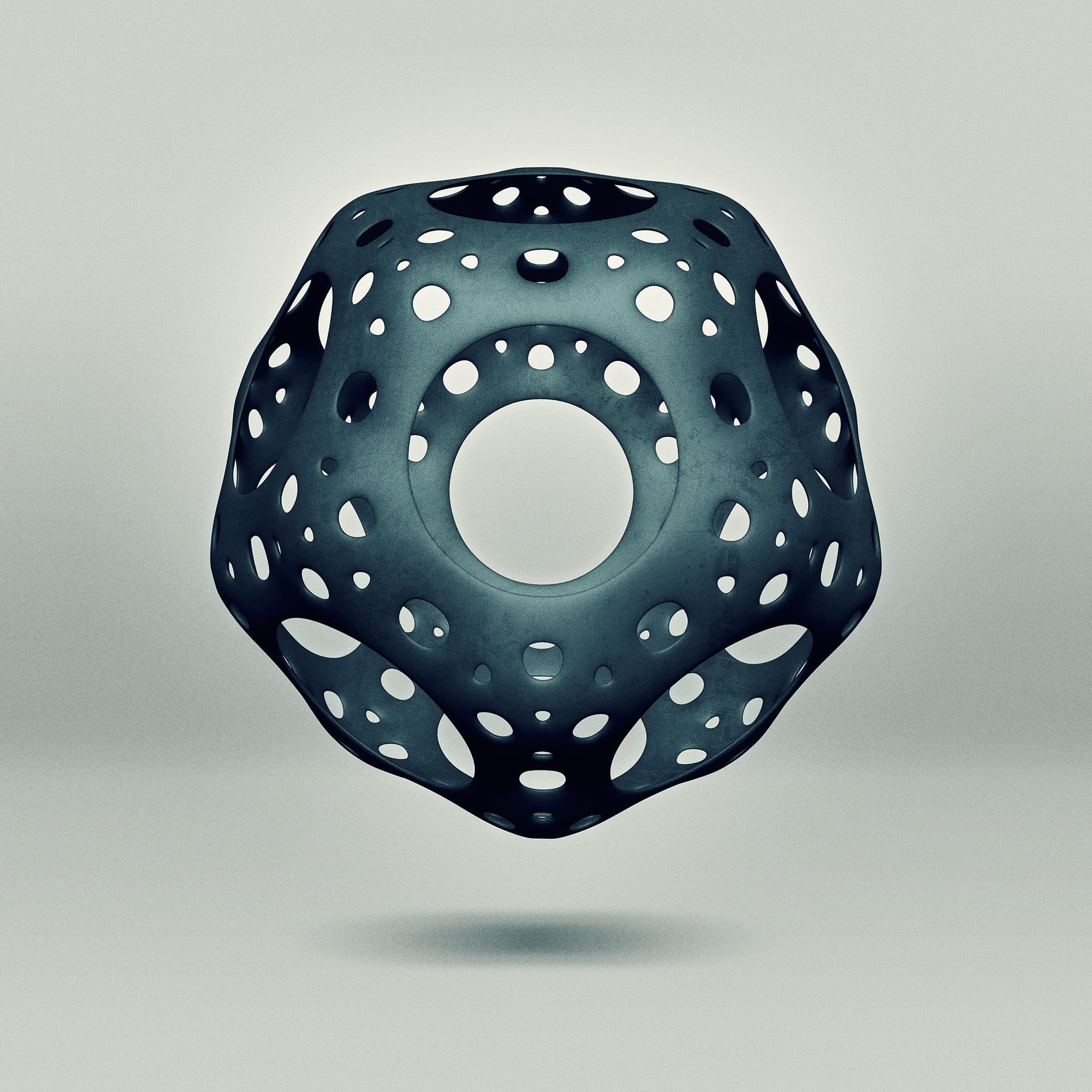 A 3D geometric sculpture with a hollow, perforated design hovers against a light gray background. The object is symmetrical, with circular and hexagonal cutouts, creating an intricate pattern resembling a futuristic architectural structure. The material appears metallic and polished.