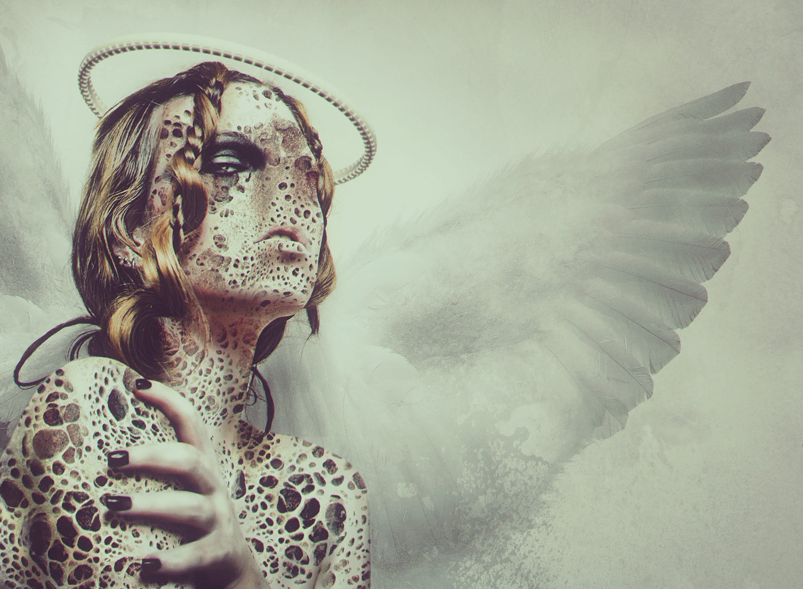 A person with textured, stone-like skin and dark nails stands in front of a winged backdrop. Their head is adorned with a pearl-like halo, and hair is partially visible. The background is a blend of soft light and shadow, creating an ethereal and mystical atmosphere.