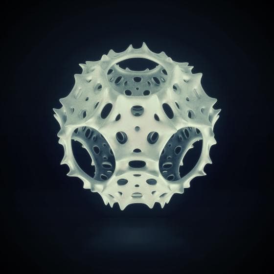 A 3D geometric shape appears suspended against a dark background. The object has a spherical form with a complex, perforated surface featuring numerous holes and spikes, giving it an organic, lattice-like appearance. The lighting highlights its intricate design.