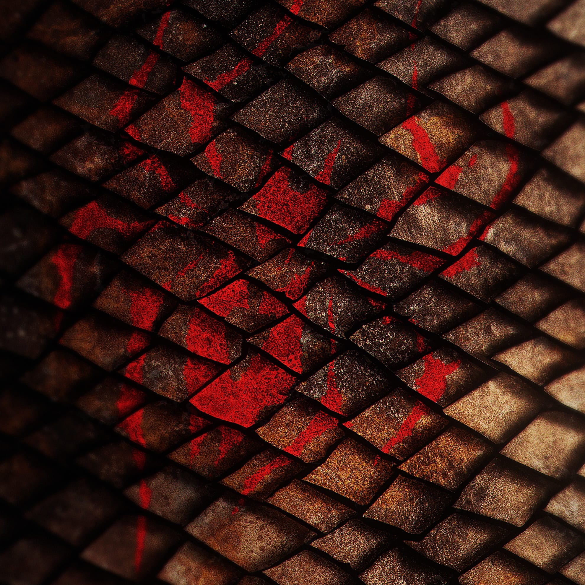Close-up image of textured reptile skin with overlapping diamond-shaped scales in shades of brown and black. A striking red pattern or mark is visible across the scales, creating a vivid contrast against the earthy colors. The lighting highlights the texture and depth of the scales.