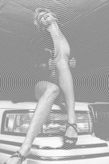 A distorted grayscale image features a person in a dynamic pose. The figure is seated on a car's hood, with spiral patterns radiating across the image, creating a dizzying effect. They wear sandals and appear to be wearing minimal clothing. The image has a vintage, surreal style.