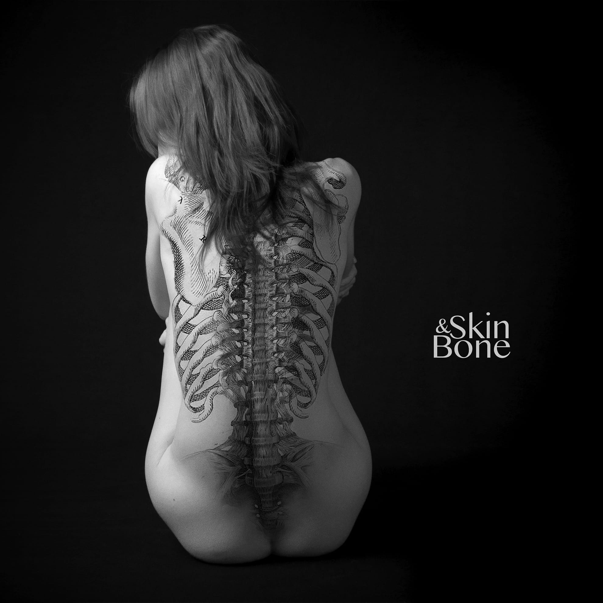 A black and white image of a person sitting with their back to the camera. The back is digitally enhanced to reveal an anatomical illustration of a spine and ribs overlaid onto the skin. The words "Skin & Bone" are written in the lower right corner. The background is dark.