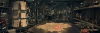 A surreal room with glass cases and shelves; swirling chaos surrounds a glowing red orb on the center table.